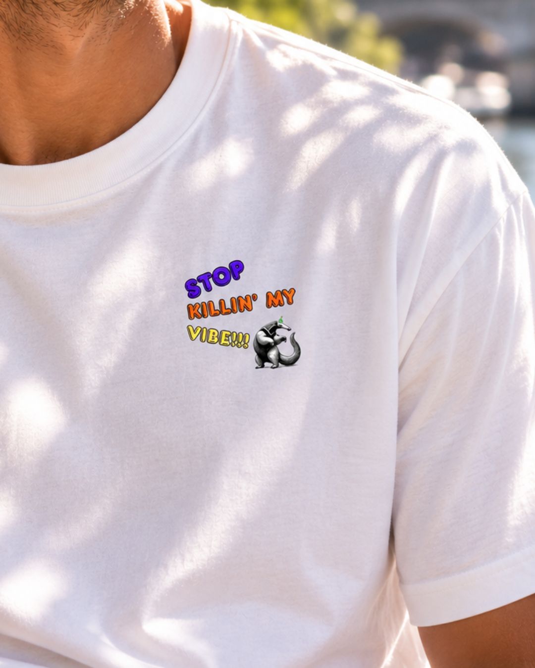 Oversized white organic cotton unisex wildlife t-shirt featuring a dancing aardvark graphic on the left chest