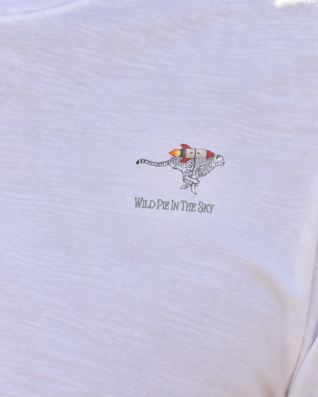 Unisex cotton long sleeve wildlife t-shirt featuring small cheetah chest graphic shown up close in white