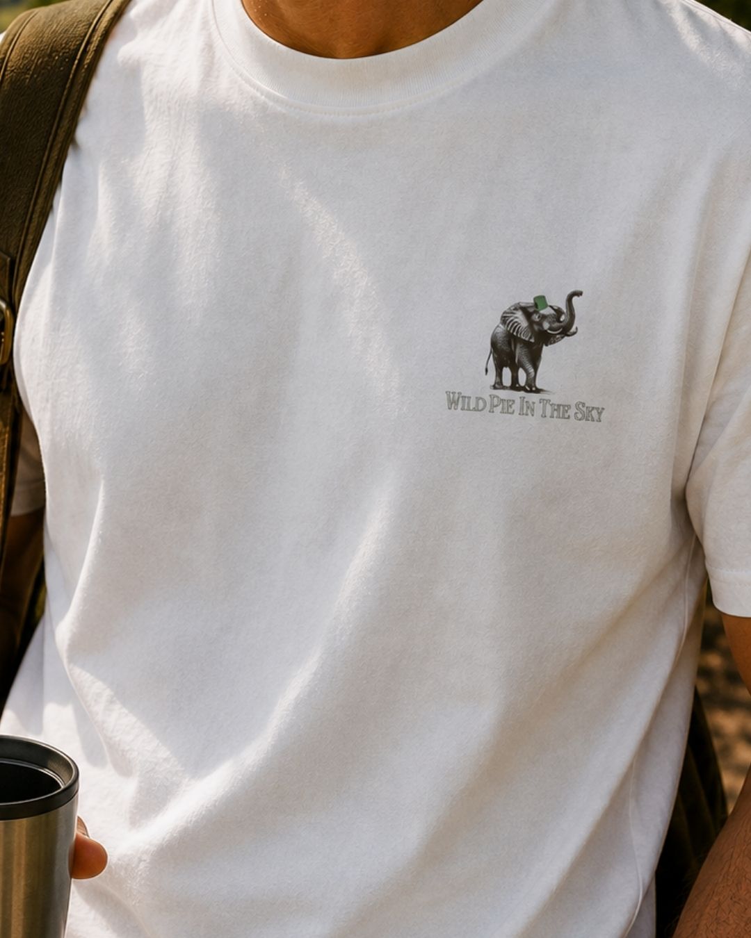 Oversized white organic cotton unisex wildlife t-shirt featuring small  elephant chest graphic