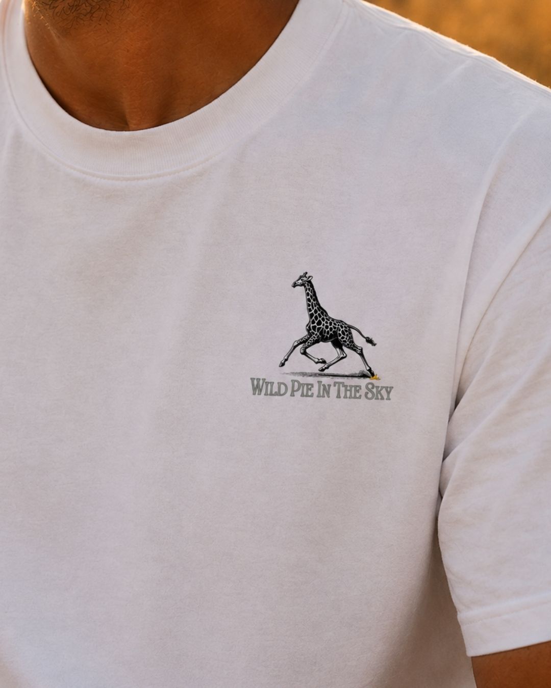 Oversized white organic cotton unisex wildlife t-shirt featuring small giraffe chest graphic