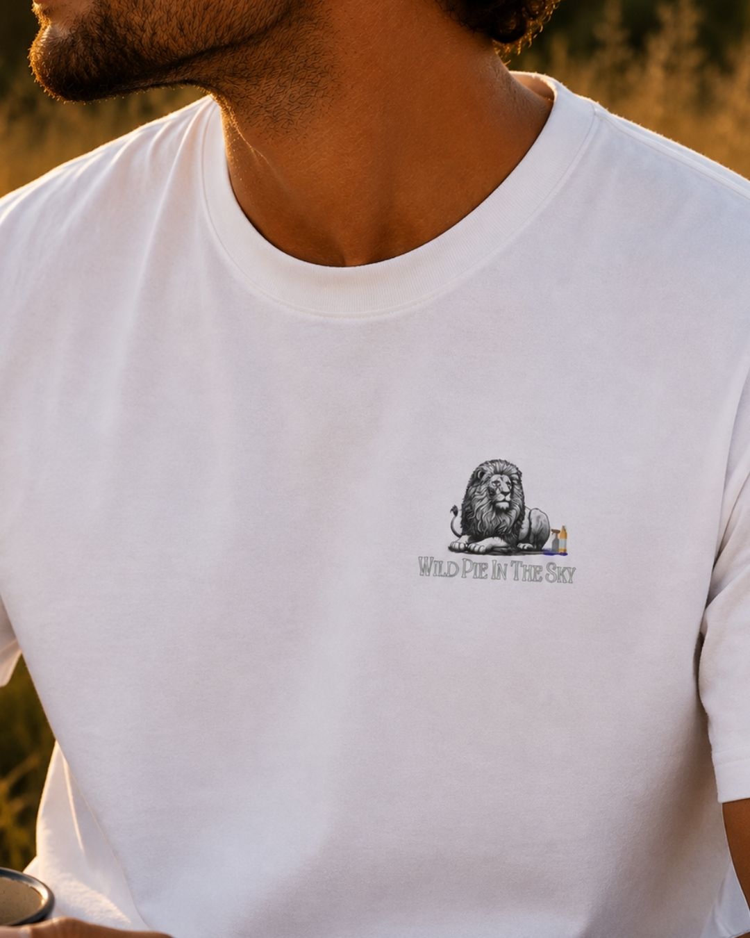 Oversized white organic cotton unisex wildlife t-shirt featuring small lion chest graphic