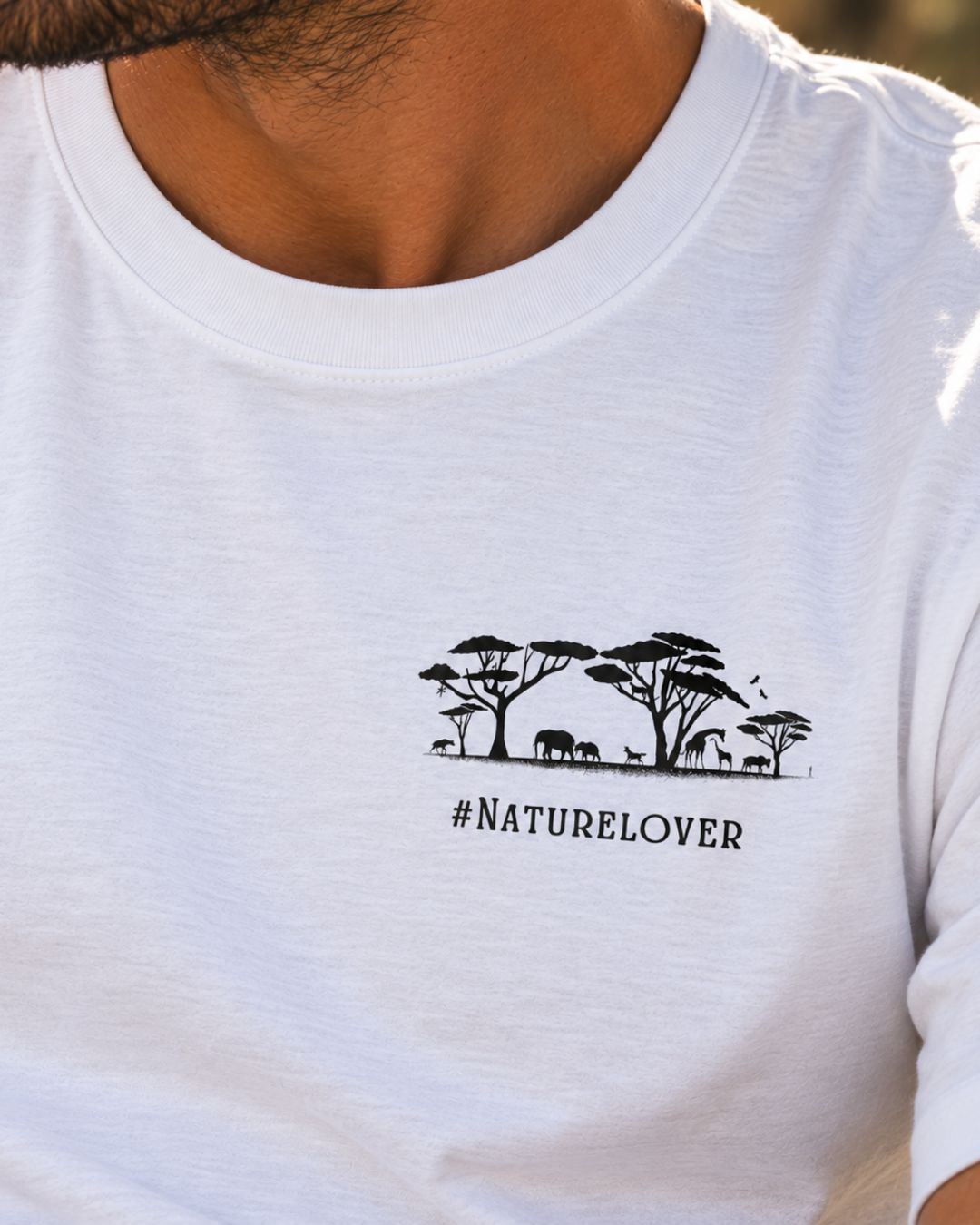 Oversized white organic cotton unisex wildlife t-shirts featuring silhouette graphic of African animals