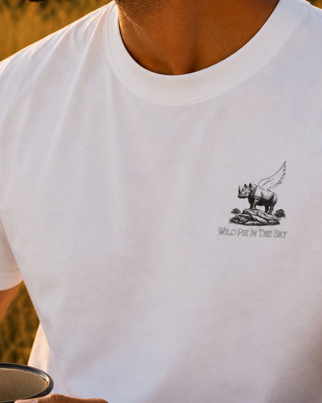 Oversized white organic cotton unisex wildlife t-shirt featuring small  winged rhino chest graphic