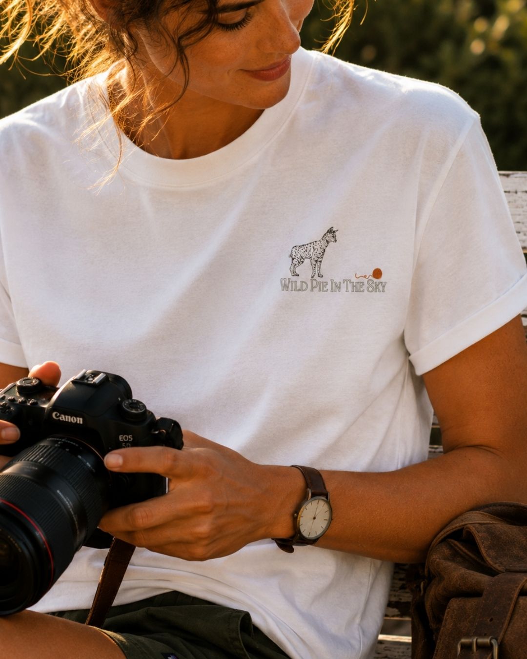 Oversized white organic cotton unisex wildlife t-shirt featuring small serval cat chest graphic