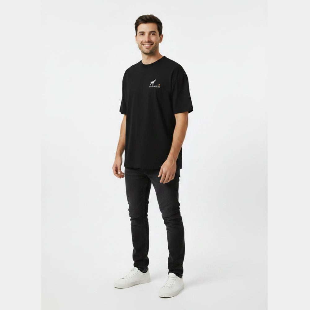 Oversized black organic cotton unisex wildlife t-shirt featuring small  serval cat chest graphic